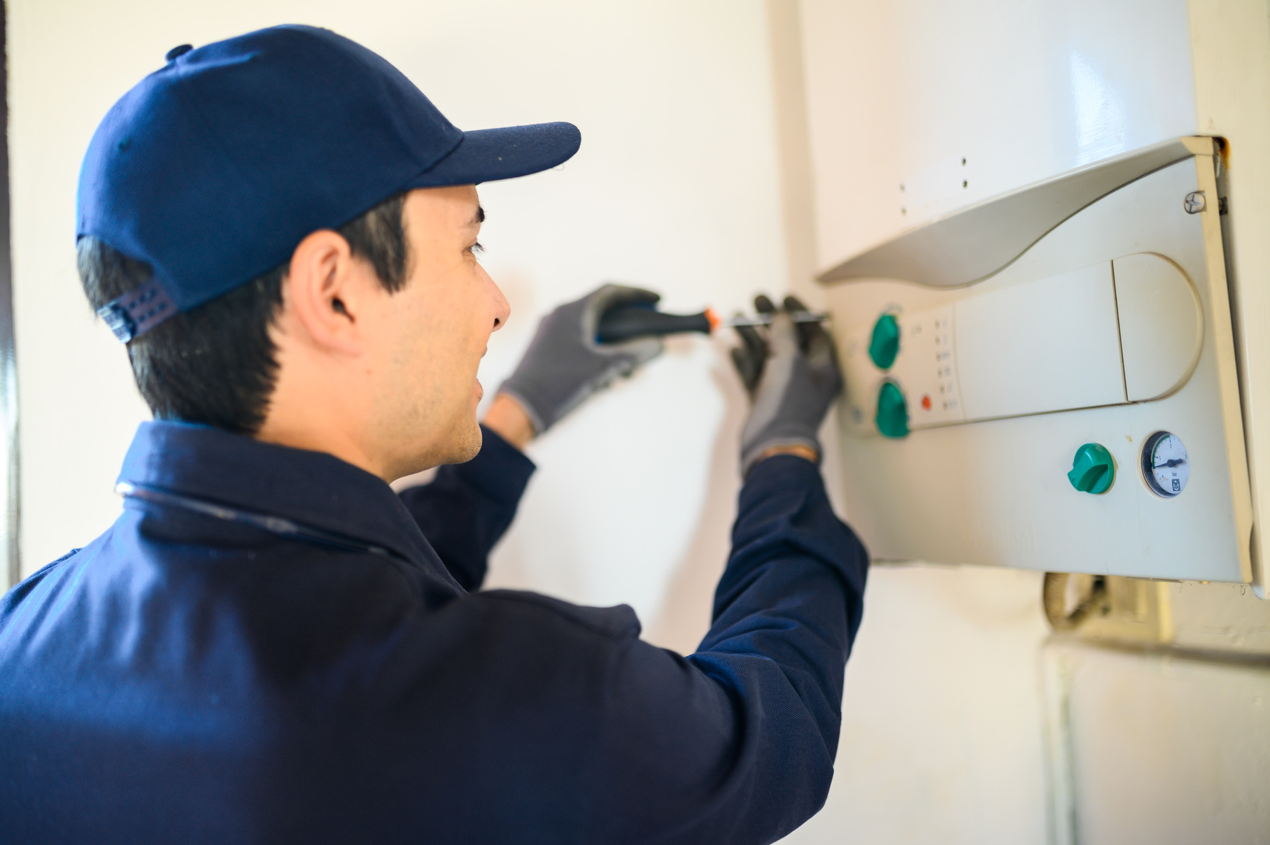 Smiling Technician Repairing an Hot-Water Heater